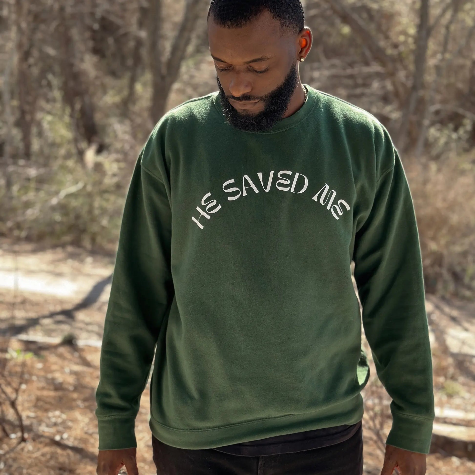 Forest Green premium crew neck sweatshirt. This sweatshirt reads "He Saved Me'" on the front in white letters. The fit is comfy and thick. From Crown of Favor Forrest Green He saved me sweatshirt crewneck. He Saved Me sweatshirt. Christian clothing brand.